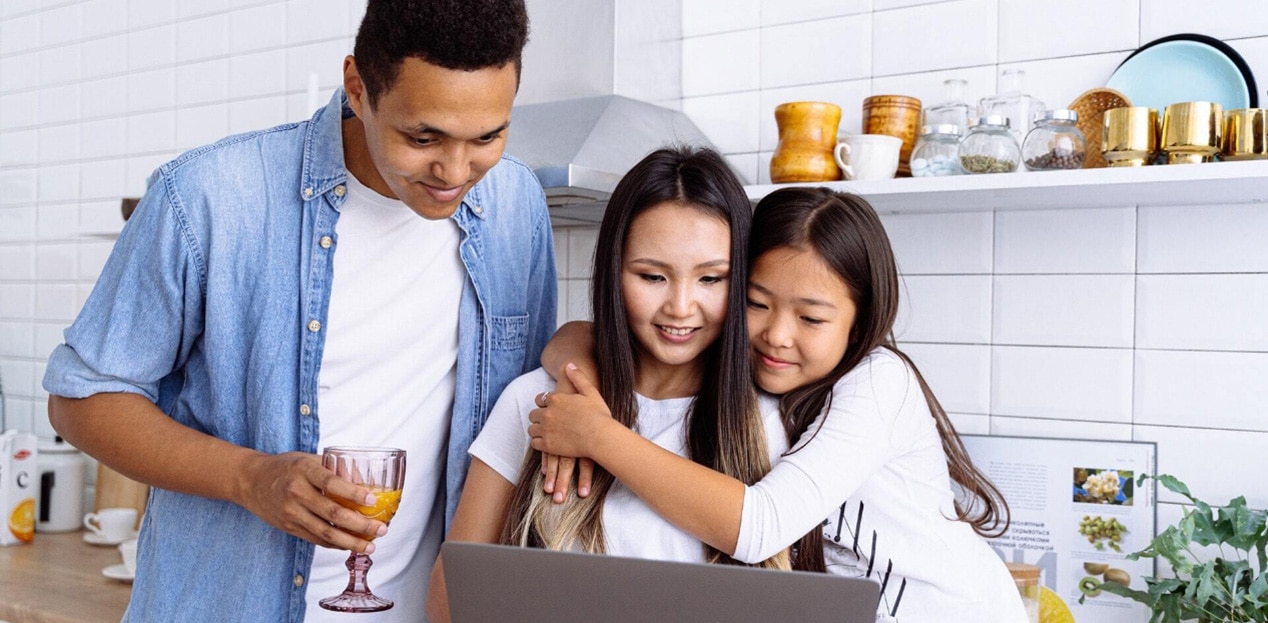 Family With Student Gathered Around Computer