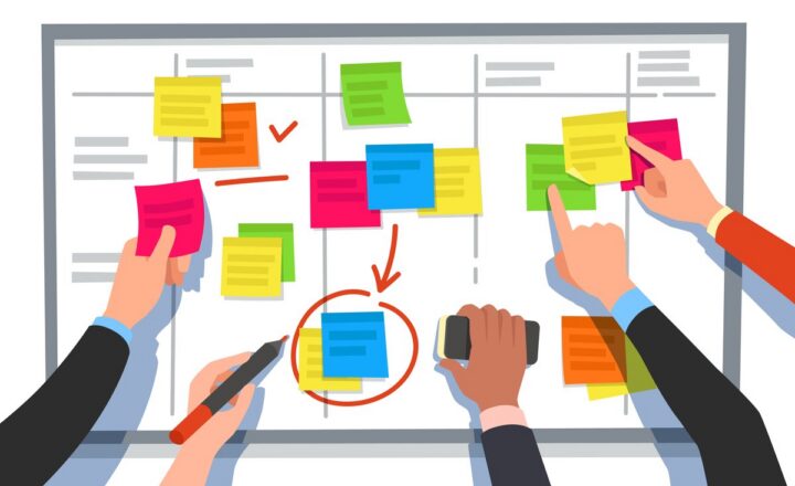 Hands arranging sticky notes on a task board, representing sprint planning